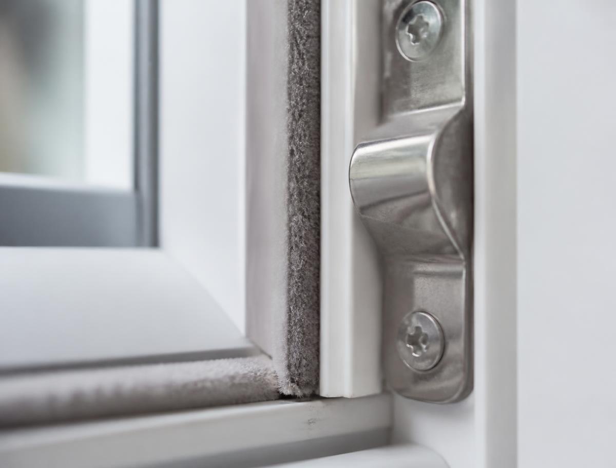Close-up of the weatherstripping and locking keeper where sash meets frame